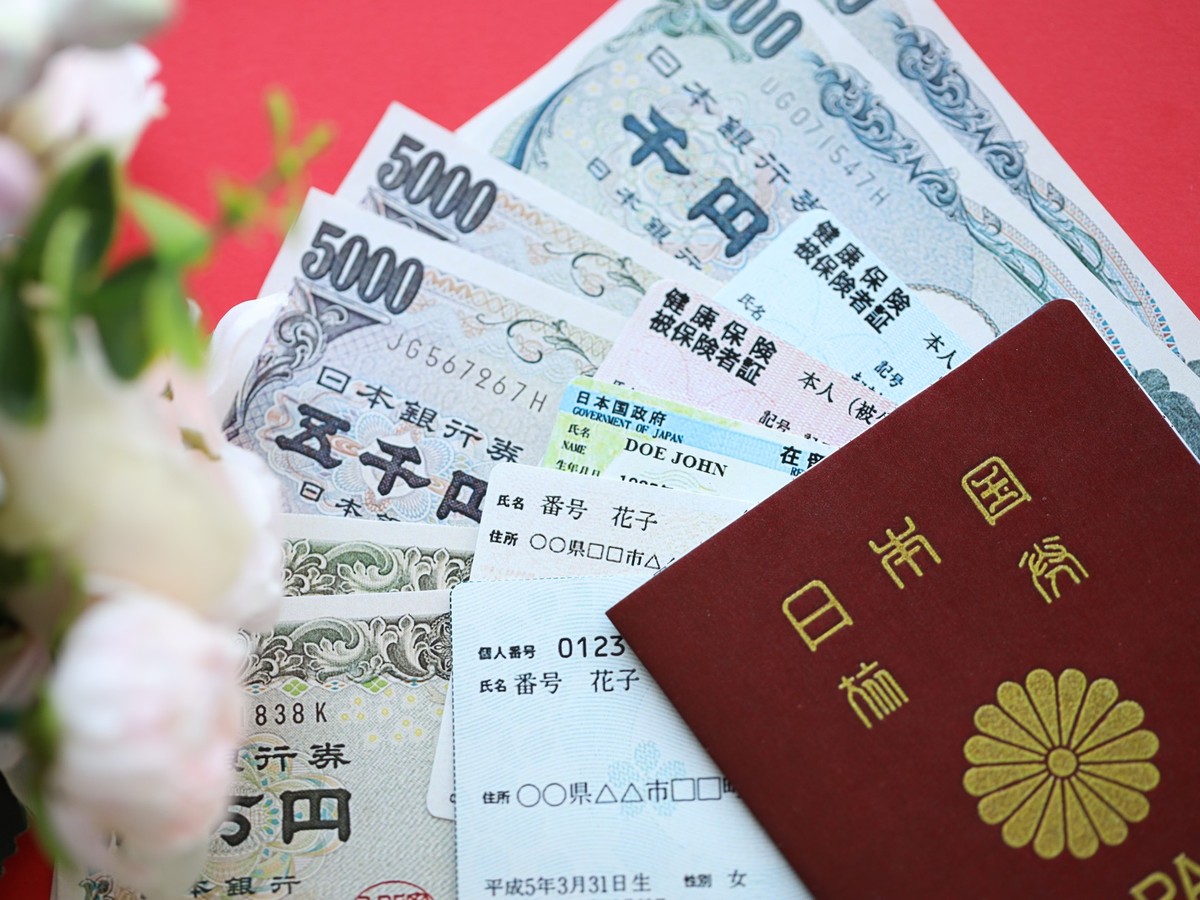 Blue and red Japan Health Insurance cards on table with japanese residence card and my number card, Light blue and red Japan Health Insurance cards on table with japanese residence card and my number  ...