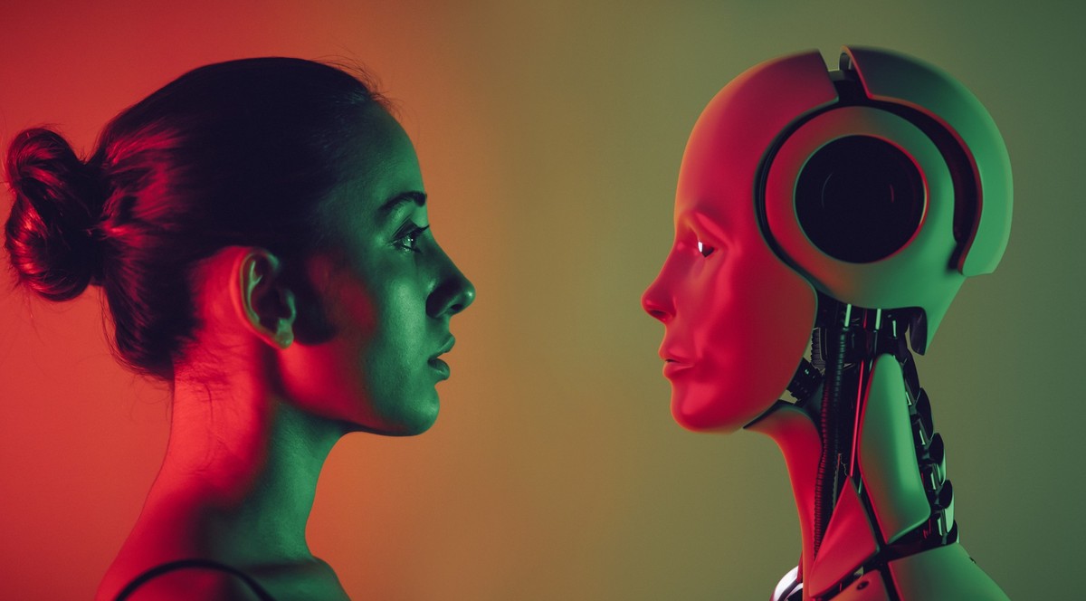Robot and young woman face to face.