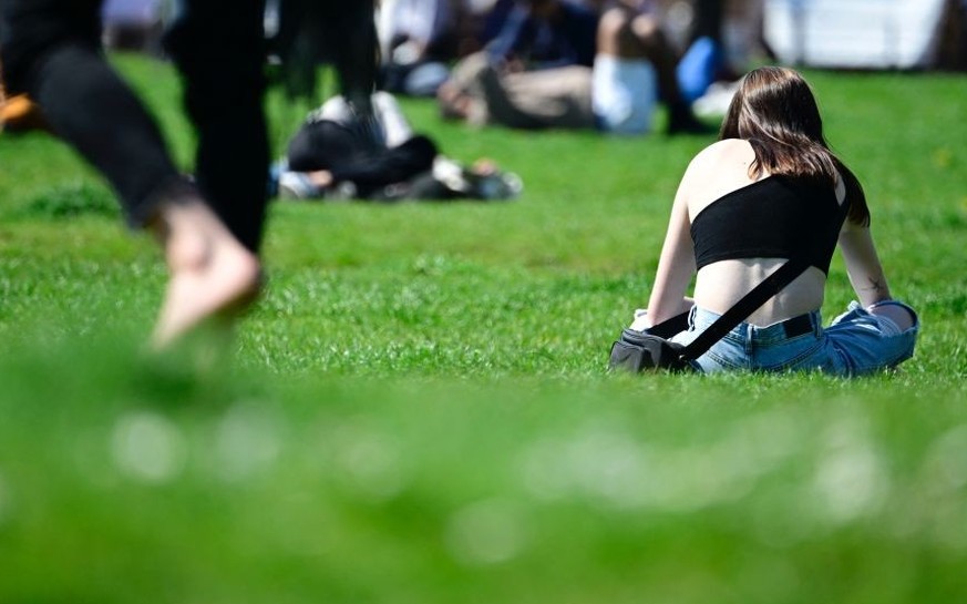 People sit in the sun in Berlin on April 22, 2023, where the tempertures reached 22 degrees celsius. (Photo by Tobias SCHWARZ / AFP) (Photo by TOBIAS SCHWARZ/AFP via Getty Images)