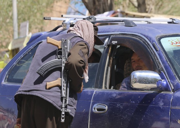 240518 -- BAMYAN, May 18, 2024 -- An Afghan security force member checks a vehicle following a shooting attack that killed three Spanish nationals on the previous day in Bamyan City, central Afghanist ...