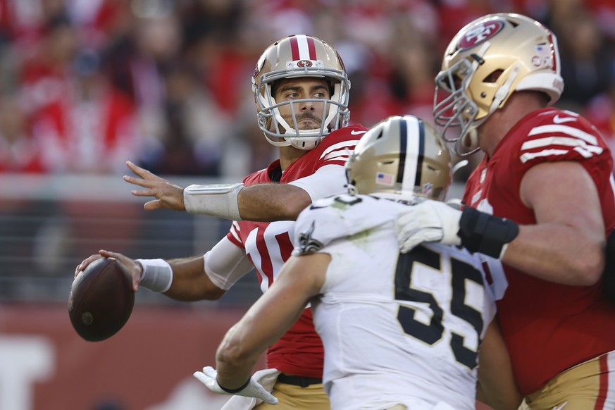 San Francisco 49ers quarterback Jimmy Garoppolo, left, passes as New Orleans Saints linebacker Kaden Elliss (55) applies pressure during the first half of an NFL football game in Santa Clara, Calif.,  ...