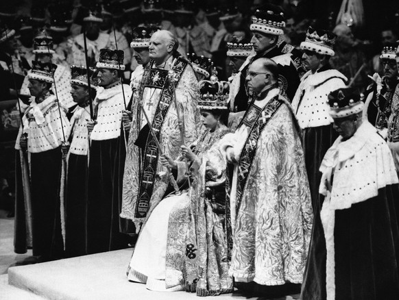 FILE - Britain&#039;s Queen Elizabeth II is crowned the Monarch of Britain holding the Royal Scepter, sat on throne, wearing St. Edward&#039;s crown, at Westminster Abbey, in London, June 2, 1953. St. ...