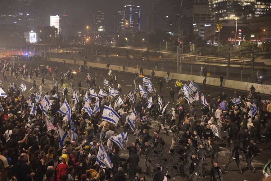 Israeli police disperse demonstrators blocking a highway during a protest against plans by Prime Minister Benjamin Netanyahu&#039;s government to overhaul the judicial system in Tel Aviv, Israel, Mond ...