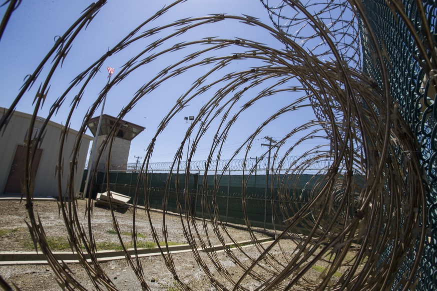FILE - In this Wednesday, April 17, 2019 file photo reviewed by U.S. military officials, the control tower is seen through the razor wire inside the Camp VI detention facility in Guantanamo Bay Naval  ...