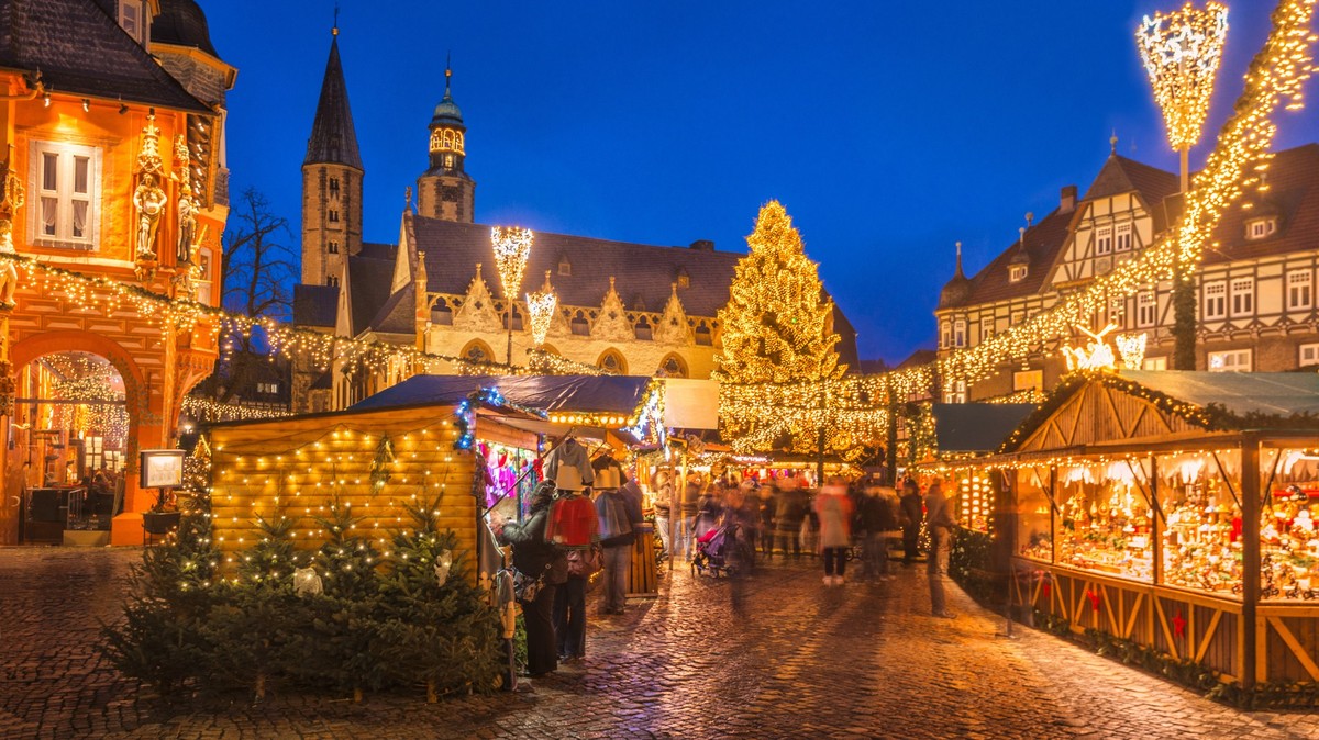 The traditional Christmas Market on the historic Market Square of Goslar, Germany at dusk.