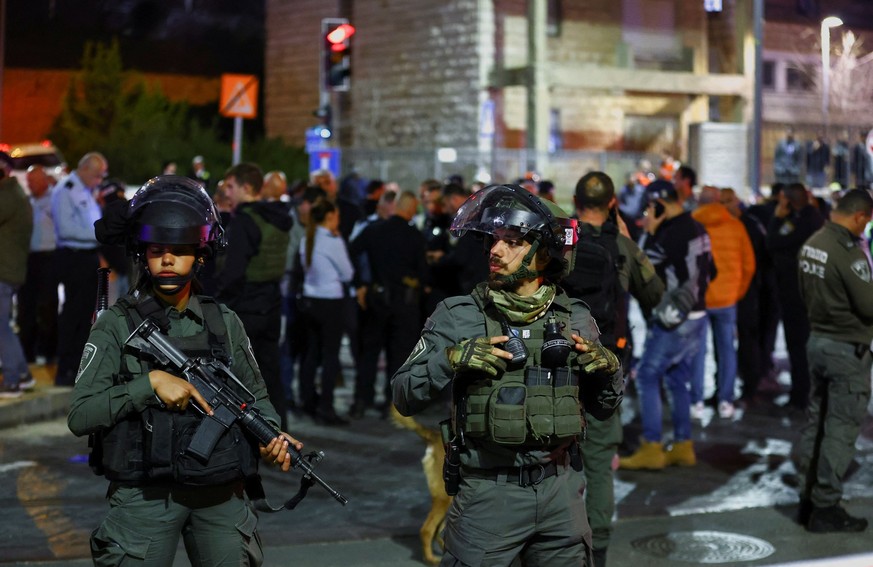 Israeli forces stand guard near the scene of a shooting attack in Neve Yaacov which lies on occupied land that Israel annexed to Jerusalem after the 1967 Middle East war January 27, 2023. REUTERS/Rone ...