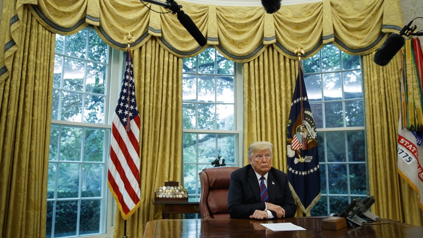 In this Aug. 27, 2018, photo, President Donald Trump listens during a phone call with Mexican President Enrique Pena Nieto about a trade agreement between the United States and Mexico, in the Oval Off ...