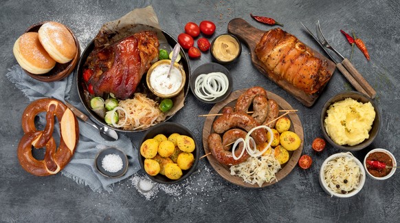 German cuisine on dark background. Traditional food concept. Grilled meat and snacks. Top view, flat lay