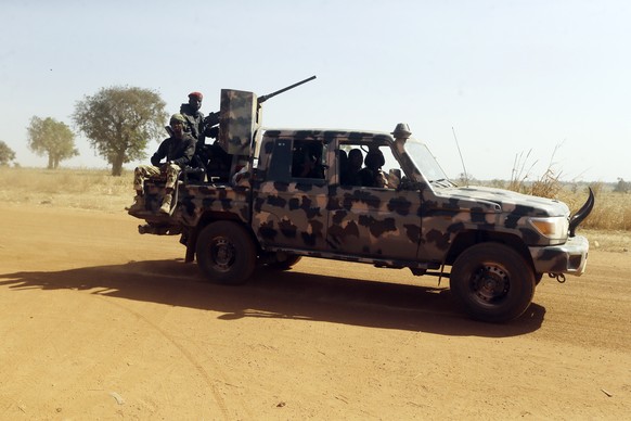 Nigerian soldiers drive past Government Science secondary school in Kankara , Nigeria, Wednesday, Dec. 16, 2020. Rebels from the Boko Haram extremist group claimed responsibility Tuesday for abducting ...
