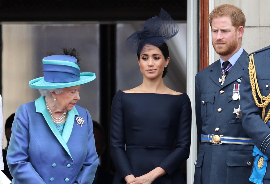 LONDON, ENGLAND - JULY 10: Queen Elizabeth II, Prince Harry, Duke of Sussex and Meghan, Duchess of Sussex on the balcony of Buckingham Palace as the Royal family attend events to mark the Centenary of ...