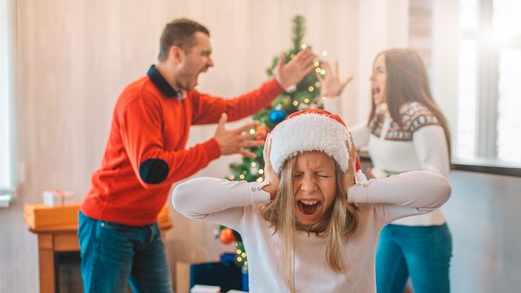 Young man and woman standing in front of each other and screaming. They argue. Girl stand in front of camera and close her ears. She is screaming too. Girl is suffering