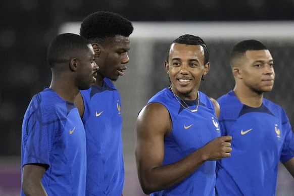 From left, France's Ousmane Dembele, Aurelien Tchouameni, Jules Kounde and Kylian Mbappe speaks during a training session in Doha, Qatar, Saturday, Dec. 3, 2022, on the eve of the World Cup soccer mat ...