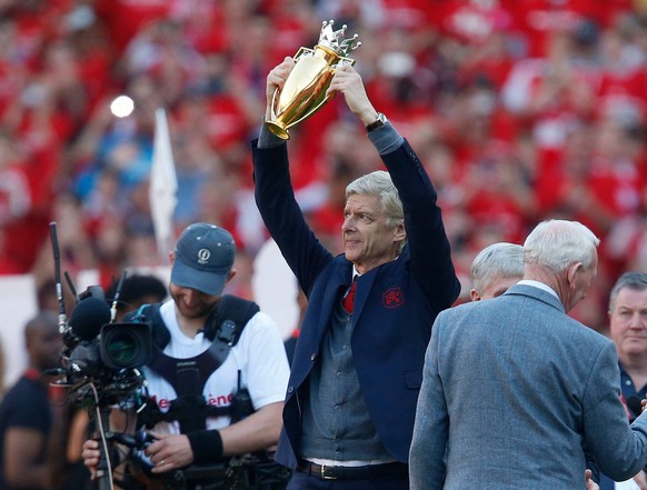 Mandatory Credit: Photo by Matthew Impey/Shutterstock 9664178af Arsene Wenger lifts the Gold Premier League Champions Trophy, won when Arsenal went the entire 2003/2004 season undefeated, which was gi ...