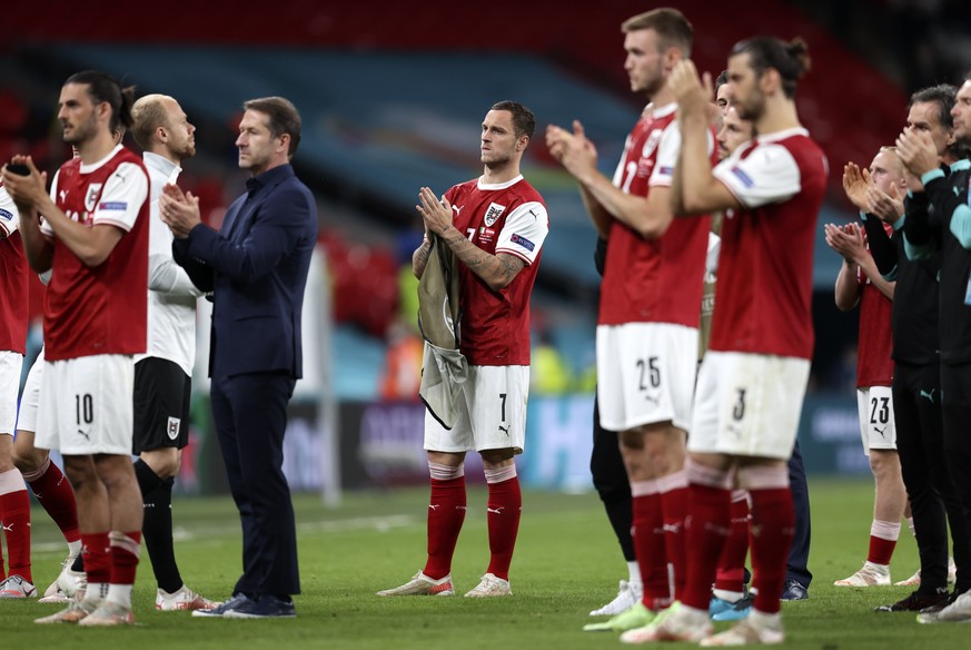 Austria&#039;s Marko Arnautovic, center, looks disappointed beside his teammates after losing the Euro 2020 soccer championship round of 16 match between Italy and Austria at Wembley stadium in London ...