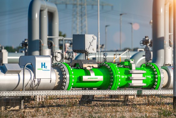 Green Hydrogen renewable energy production pipeline - green hydrogen gas for clean electricity solar and windturbine facility.