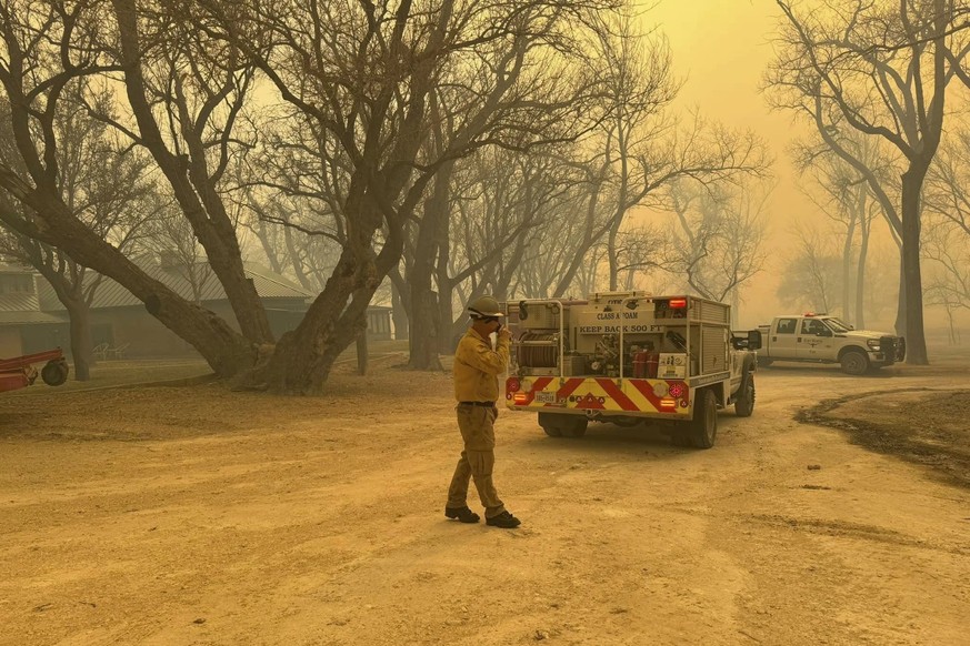 In this photo provided by the Flower Mound, Texas, Fire Department, Flower Mound firefighters respond to a fire in the Texas Panhandle, Tuesday, Feb. 27, 2024. A rapidly widening Texas wildfire double ...