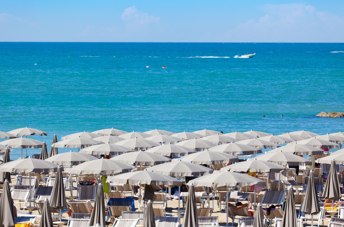 long rows of beach umbrellas and beds in Rimini, Emilia RomagnaOTHER BEACH SCENES FROM ITALY: