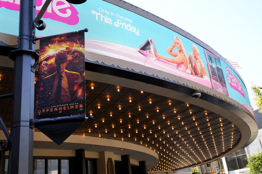 Advertisements for the films &quot;Oppenheimer&quot; and &quot;Barbie&quot; appear at AMC Theaters at The Grove on Thursday, July 20, 2023, in Los Angeles. (AP Photo/Chris Pizzello)