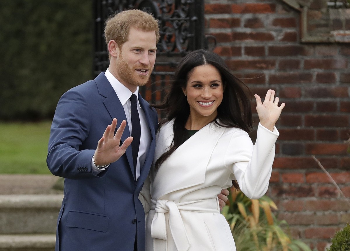 FILE - Britain's Prince Harry and his fiancee Meghan Markle pose for photographers during a photocall in the grounds of Kensington Palace in London, Monday Nov. 27, 2017. (AP Photo/Matt Dunham, F ...