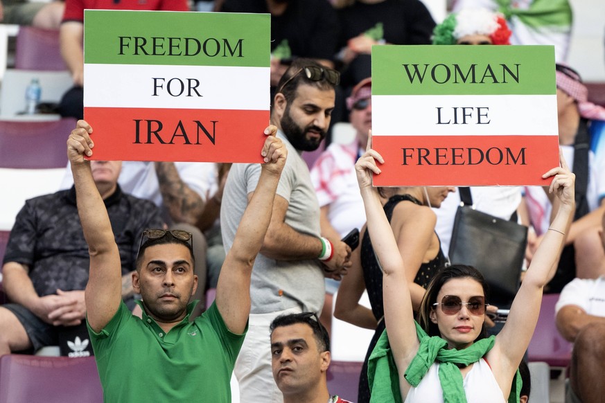 DOHA, QATAR - NOVEMBER 21: Iran fans hold up protest signs ahead of the FIFA World Cup, WM, Weltmeisterschaft, Fussball Qatar 2022 Group B match between England and IR Iran at Khalifa International St ...