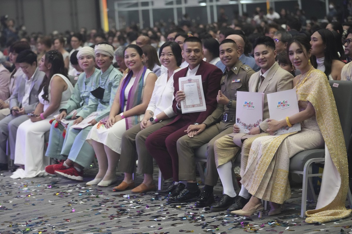 Couples from the LGBTQ+ community show their marriage certificates after the Marriage Equality Act took effect in Bangkok, Thailand, Thursday, Jan. 23, 2025. (AP Photo/Sakchai Lalit)