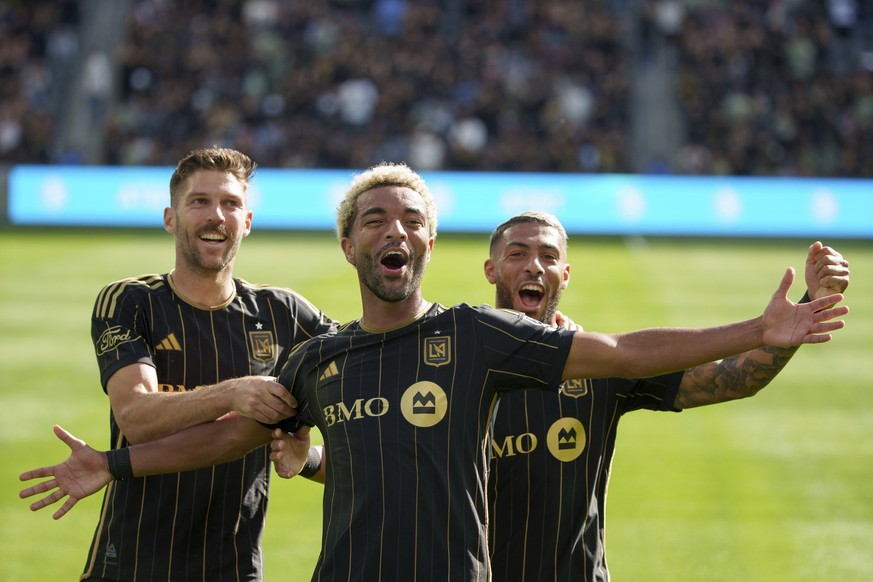Los Angeles FC midfielders Ryan Hollingshead, left, and Timothy Tillman, center, and forward Denis Bouanga celebrate a goal during the first half of an MLS soccer match against the Seattle Sounders, S ...
