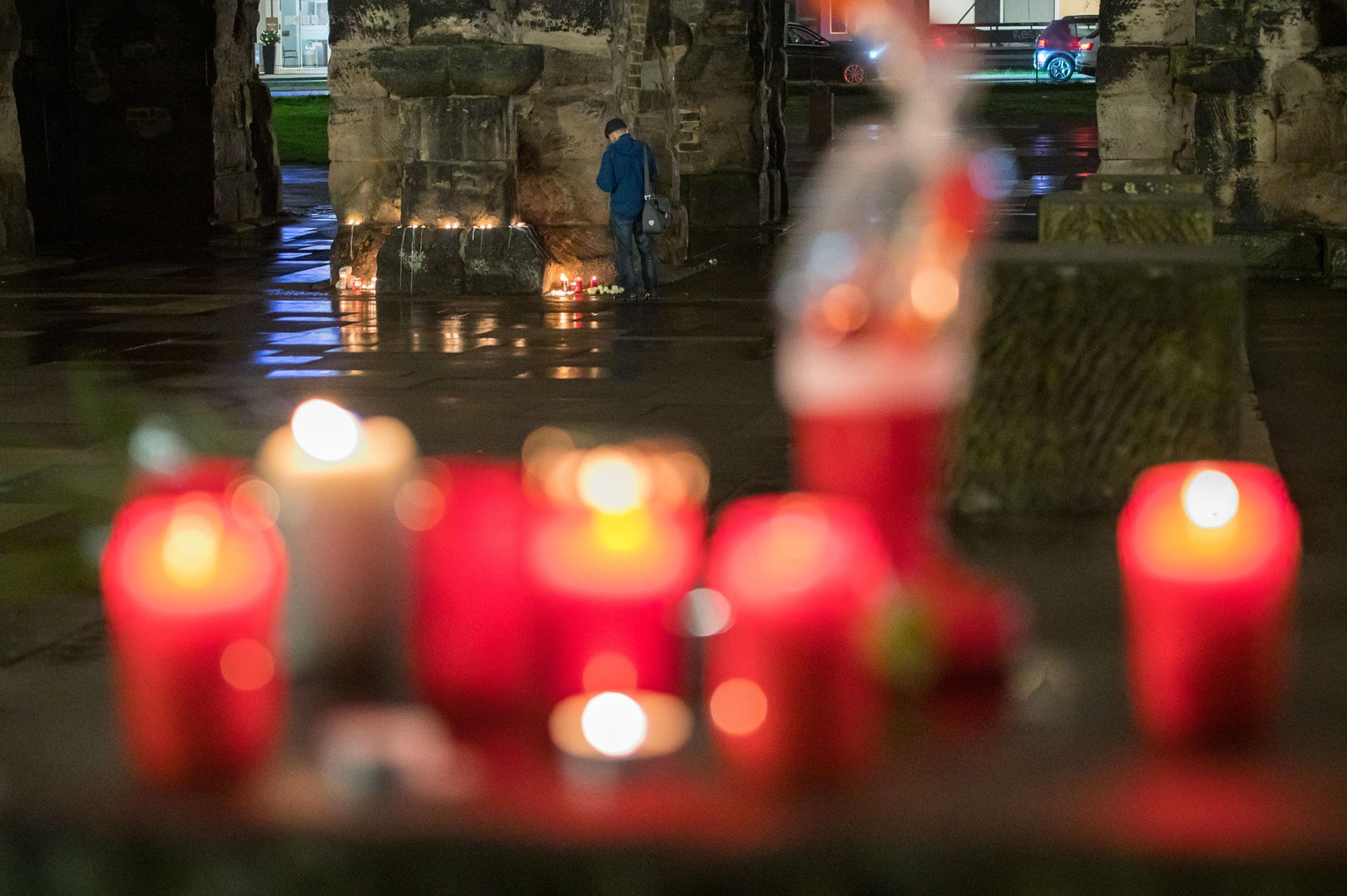 01.12.2020, Rheinland-Pfalz, Trier: Menschen haben an der Porta Nigra Kerzen angezündet. Am Nachmittag war ein Mann mit einem Auto durch die Fußgängerzone von Trier gefahren und hat dabei Menschen ver ...