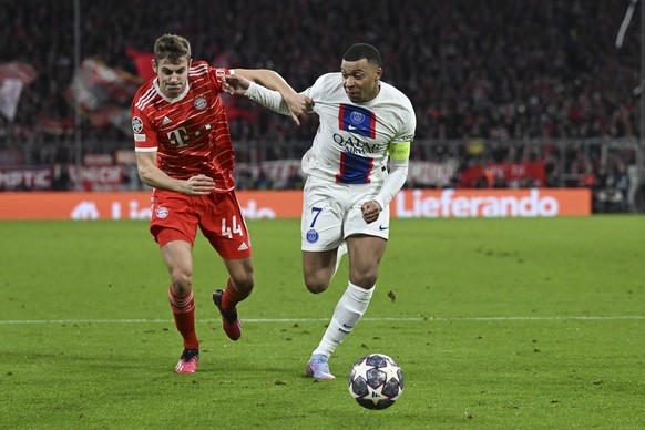 Bayern&#039;s Josip Stanisic, left, challenges for the ball with PSG&#039;s Kylian Mbappe during the Champions League round of 16 second leg soccer match between Bayern Munich and Paris Saint Germain  ...