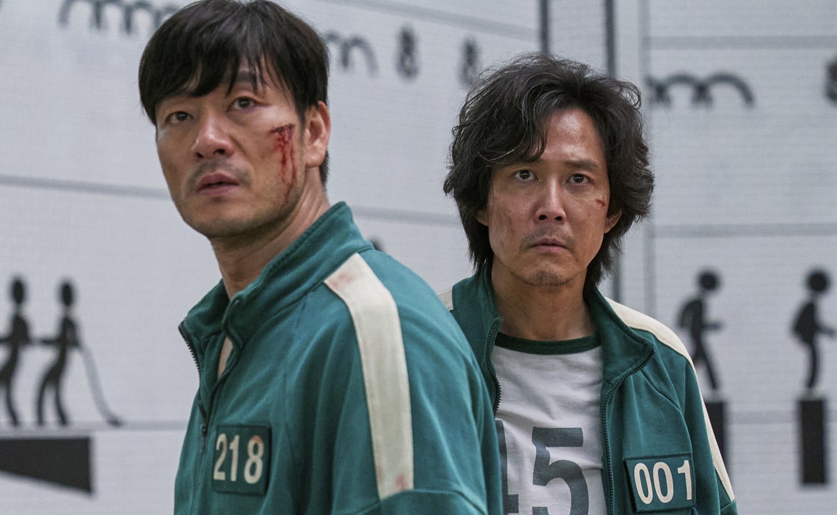This image released by Netflix shows Lee Jung-jae, right, and Park Hae-soo in a scene from the Korean series &quot;Squid Game.&quot; (Netflix via AP)