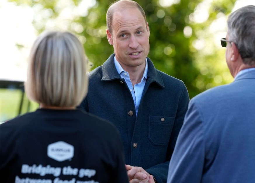 SUNBURY, ENGLAND - APRIL 18: Prince William, Prince of Wales is greeted as he arrives for a visit to Surplus to Supper, in Sunbury-on-Thames on April 18, 2024 in Surrey, England. The Prince visited Su ...