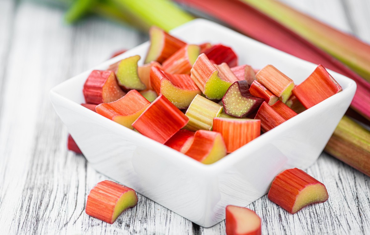 Chopped Rhubarb on an old wooden table (close up shot; selective focus)