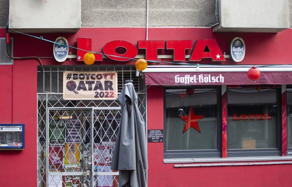 ARCHIV - 05.11.2022, Nordrhein-Westfalen, Köln: Die Kneipe Lotta in der Kölner Südstadt boykottiert die Fußball-WM-Spiele in Katar und hat über dem Eingang ein Banner mit der Aufschrift «#Boycott Qata ...