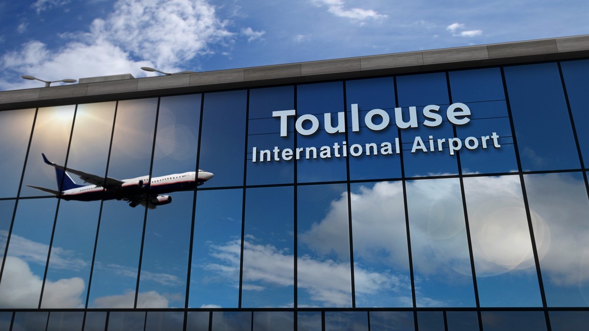 Jet aircraft landing at Toulouse, France 3D rendering illustration. Arrival in the city with the glass airport terminal and reflection of the plane. Travel, business, tourism and transport concept.