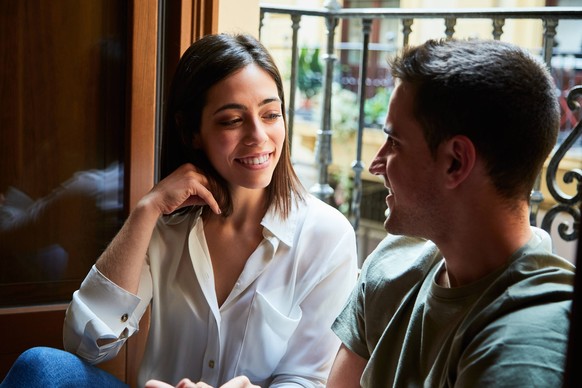 Young intimate couple relaxing next to a window with a balcony at home. Granada, AL, Spain PUBLICATIONxINxGERxSUIxAUTxONLY CRANOV200604-394493-01 ,model released, Symbolfoto ,property released