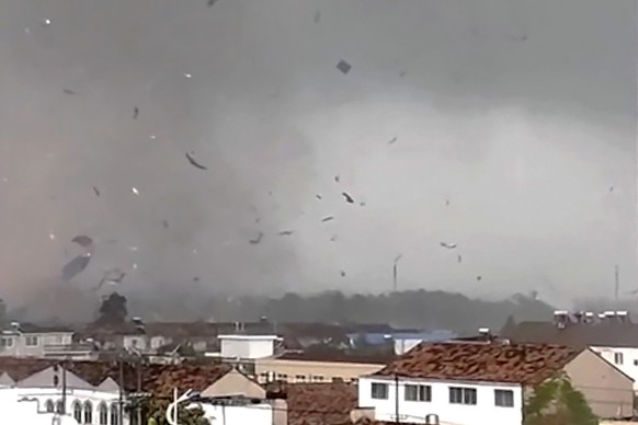 In this frame taken from a video, debris scatters in the sky after a tornado swept through houses in Suqian city in eastern China&#039;s Jiangsu Province on Tuesday, Sept. 19, 2023. Two tornadoes with ...