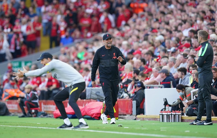 Liverpool v Chelsea - Premier League - Anfield Chelsea manager Thomas Tuchel left and Liverpool manager Jurgen Klopp centre during the Premier League match at Anfield, Liverpool. Picture date: Saturda ...