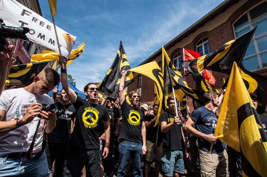 July 20, 2019 - Halle Saale, Sachsen Anhalt, Germany - Young right-extremists with the white supremacist Identitaere Bewegung (Generation Identity hold flags with the symbol of the group at a rally in ...
