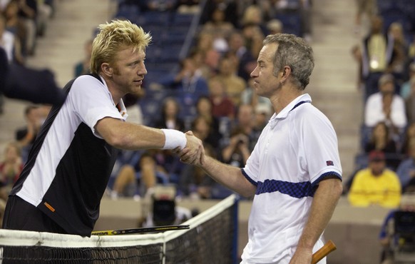 FLUSHING, NY - SEPTEMBER 7: Boris Becker of Germany shakes hands with John McEnroe of the USA before playing an exhibition match during the US Open at the USTA National Tennis Center on September 7, 2 ...