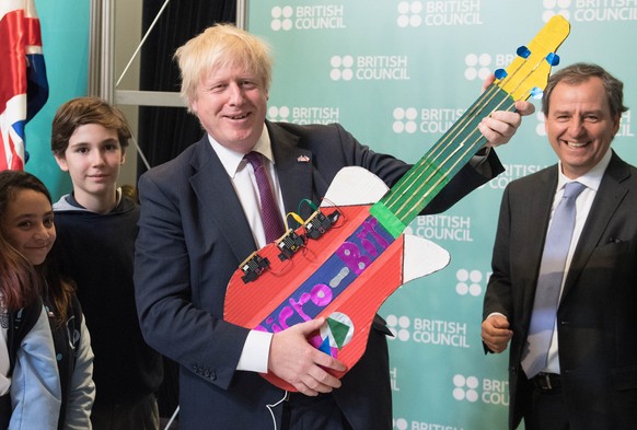 Brexit. File photo dated 23/05/18 of Boris Johnson playing with a homemade electronic guitar made by Chilean school children. Mr Johnson has sensationally resigned as Foreign Secretary, throwing the G ...