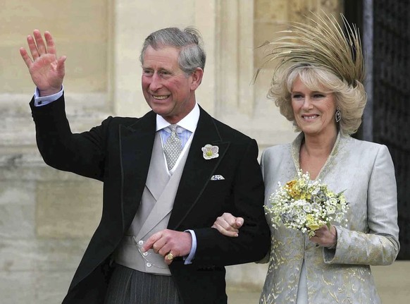 FILE - Britain's Prince Charles with his new wife Camilla, Duchess of Cornwall acknowledges the crowd following a Service of Prayer and Dedication at St. George's Chapel at Windsor Castle, Saturday, A ...