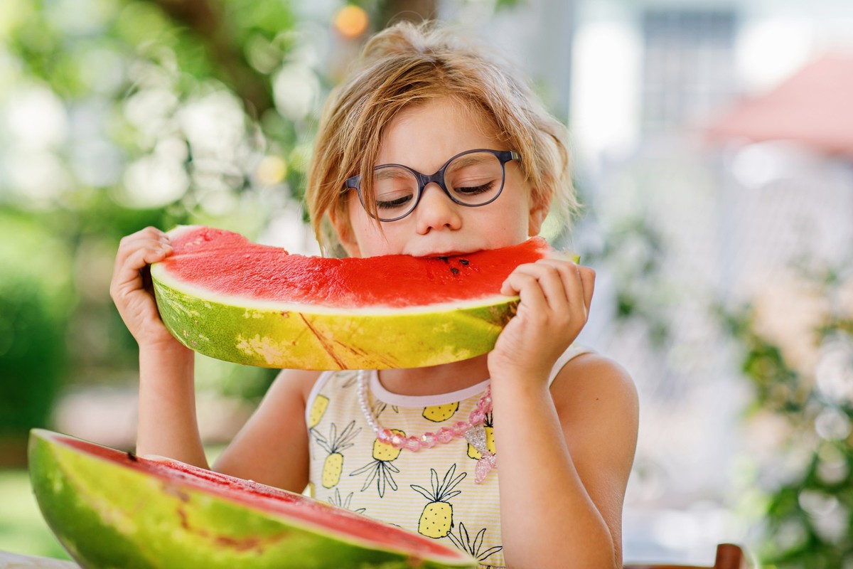 Little Girl, Preschooler, Delights in a Juicy Watermelon on a Sunny Summer Day. Child sharing a Healthy Snack with Her Family, She Embraces the Joy of Summertime Bliss. Model Released Property Release ...