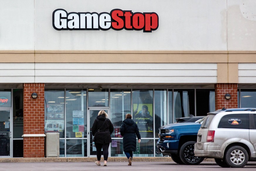 US: GameStop shares hit record high Two people walk toward a GameStop store at Buckhorn Plaza. GameStop share price reached a new record high on January 22, 2021 fueled by changes to its board of dire ...