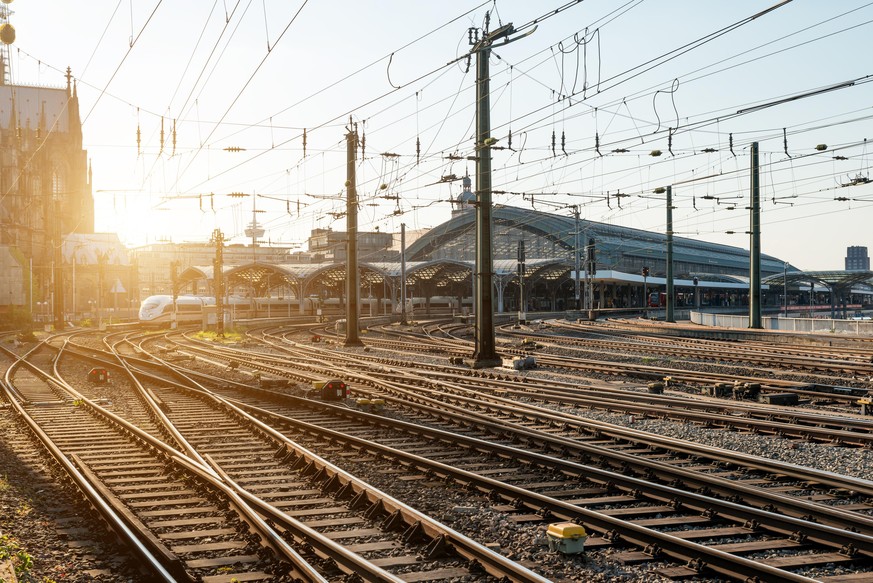 Train railroad tracks at Europe major train station at sunrise.