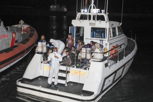 Crotone, the landing stages of 75 Iraqi Kurdish refugees arrived in the port of Crotone after being intercepted by a patrol boat of the Guardia di Finanza 12 nautical miles in front of the Calabrian c ...