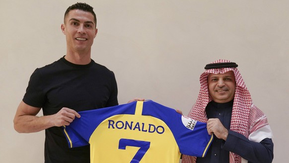 Cristiano Ronaldo L holds a team jersey of Saudi Arabian club Al Nassr with his name and No. 7 on it, in Madrid, Spain on Friday, December 30, 2022. Ronaldo has signed with the Saudi Arabian club in a ...