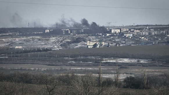 Smoke raises after shelling in Soledar, Donetsk region, Ukraine, Wednesday, Jan. 11, 2023. (AP Photo/Libkos)