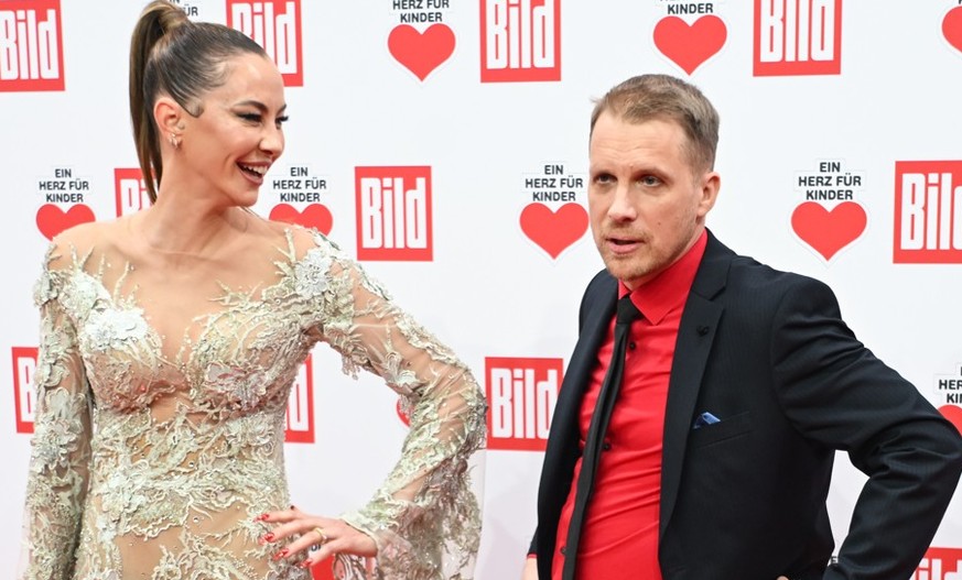 dpatopbilder - 9 dicembre 2023, Berlino: Oliver Bucher, conduttore televisivo, e Alessandra Mayer-Wolden sul tappeto rosso della raccolta fondi televisiva 