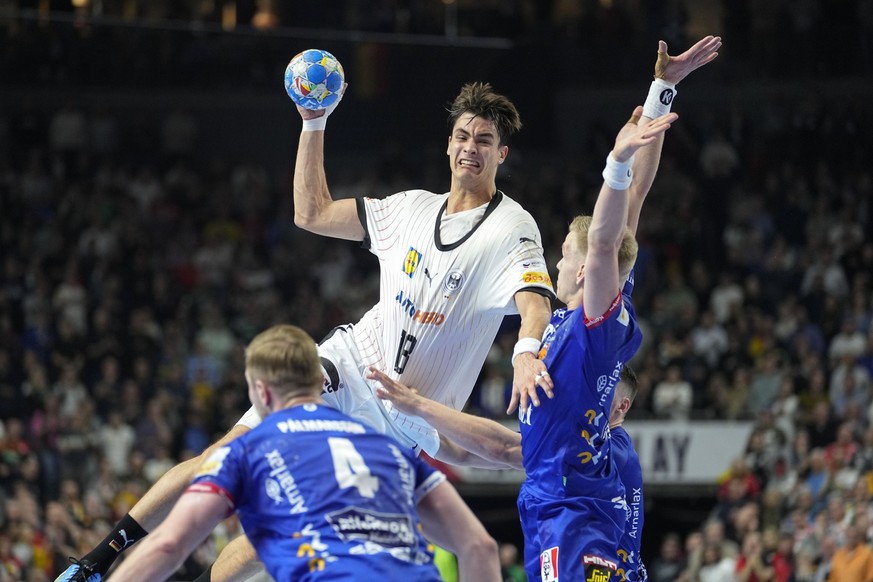 Germany&#039;s Julian Köster jumps against Iceland&#039;s defense during the Handball European Championship main round match between Germany and Iceland in Cologne, Germany, Thursday, Jan. 18, 2024. ( ...