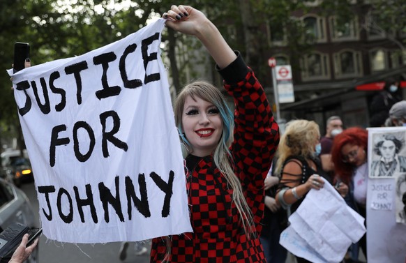 A supporter of actor Johnny Depp holds a banner outside the High Court in London, Britain July 28, 2020. REUTERS/Simon Dawson