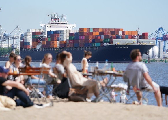 12.07.2022, Hamburg: Passanten genie�en das Sonnenwetter am Elbstrand in Ovelg�nne. Foto: Marcus Brandt/dpa +++ dpa-Bildfunk +++